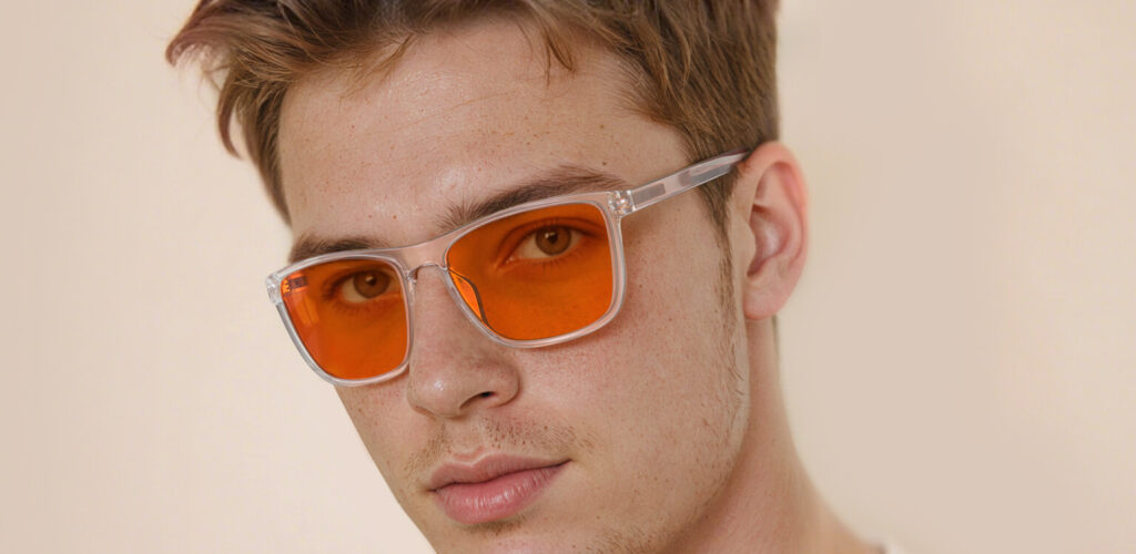 Left side view of man wearing Night Ease™ Wayfarer Orange Sleep Glasses