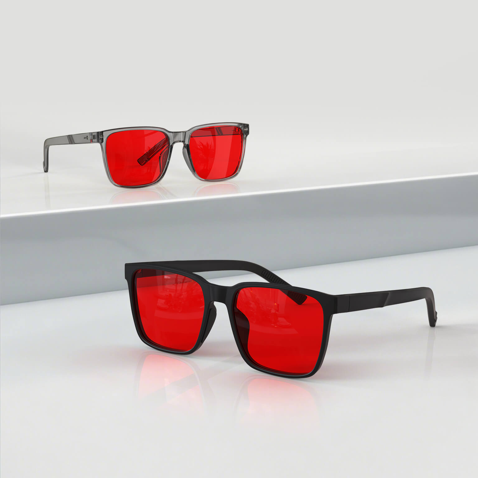 Night Ease™ Square Red Lens Sleep Glasses in black and grey frames shown side by side