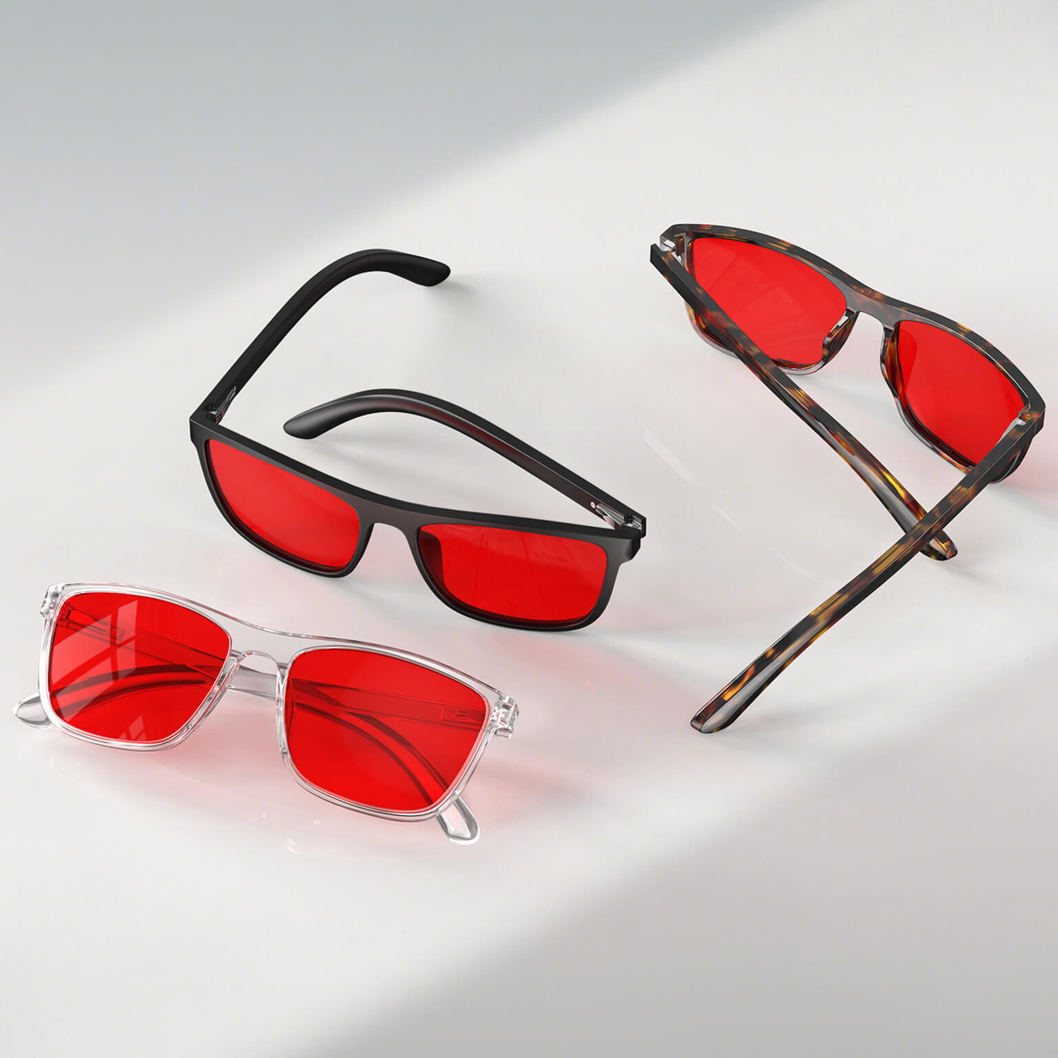 Night Ease™ Wayfarer Red Lens Sleep Glasses in black, clear, and tortoiseshell frames shown side by side