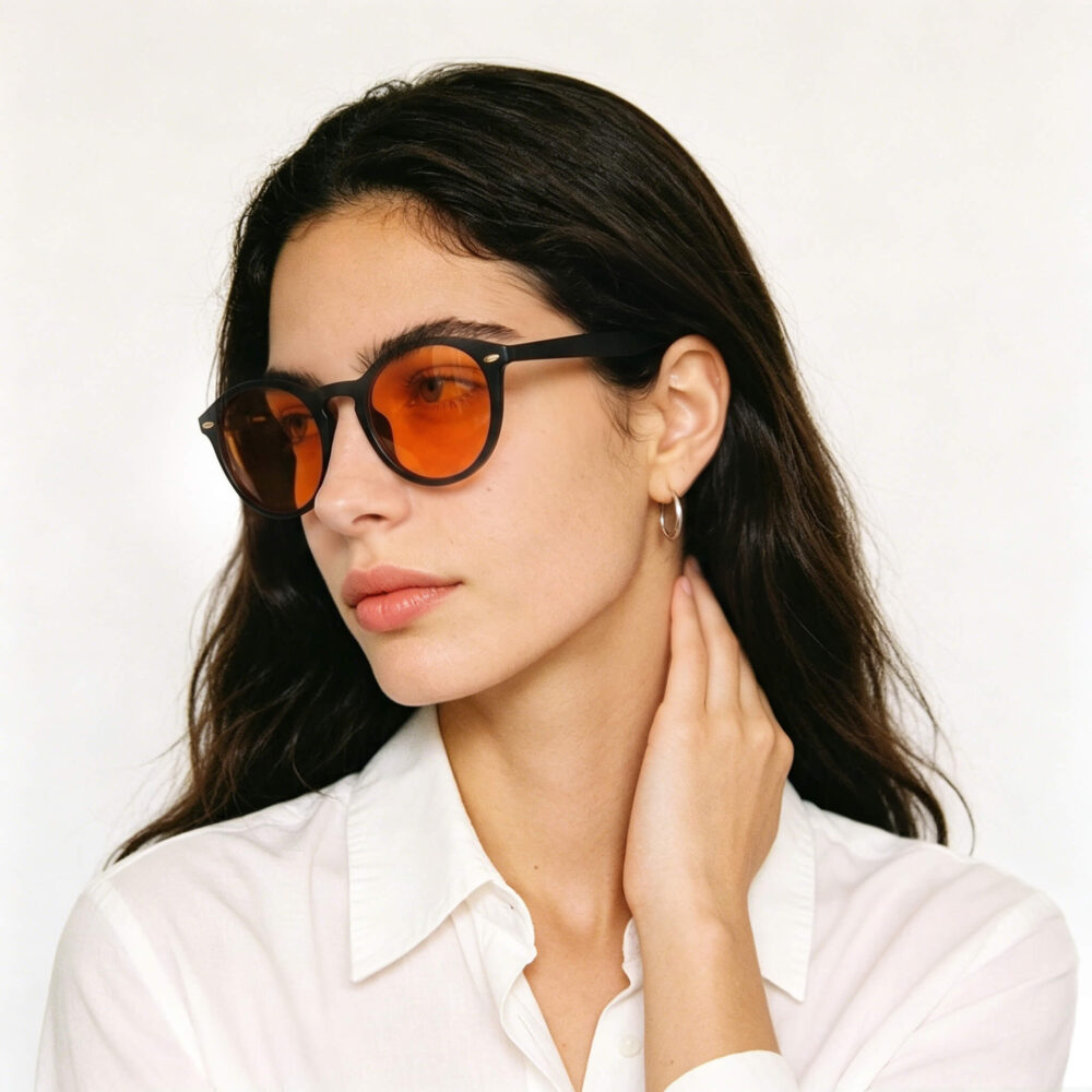 158-Female model showcasing Gloojo Night Ease orange-lens glasses for optimal recovery preparation