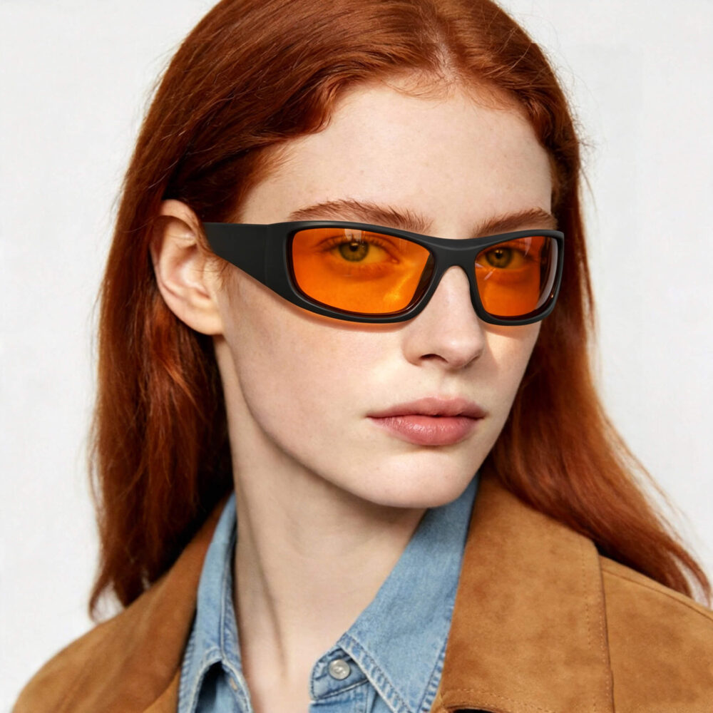 318-Female model wearing Gloojo Night Ease orange lenses in a sleek wrap-around frame 318-Female model wearing Gloojo Night Ease orange lenses in a sleek wrap-around frame
