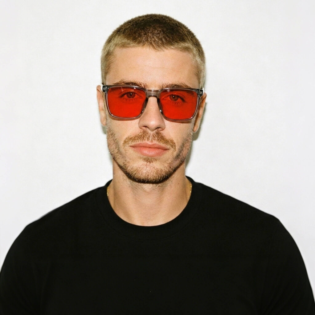 8810-Male model wearing Gloojo Night Ease sleep glasses with red-tinted lenses