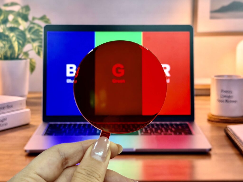 An RGB test screen viewed through an orange lens, with the blue panel visibly darker while the uncovered half remains bright